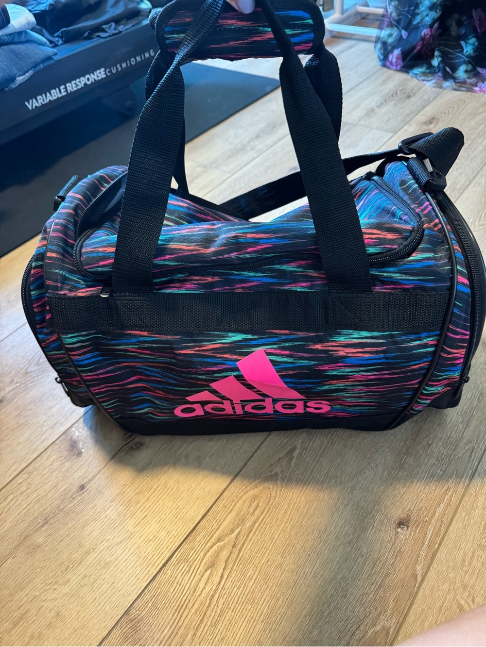 Adidas Defender II Small Duffel Bag with a pink, blue, and black striped design